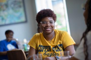 A student enjoying her meal in the dining hall