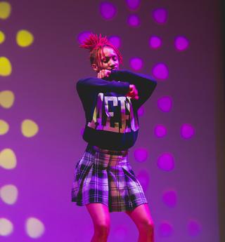 A student performs on stage during the homecoming step show